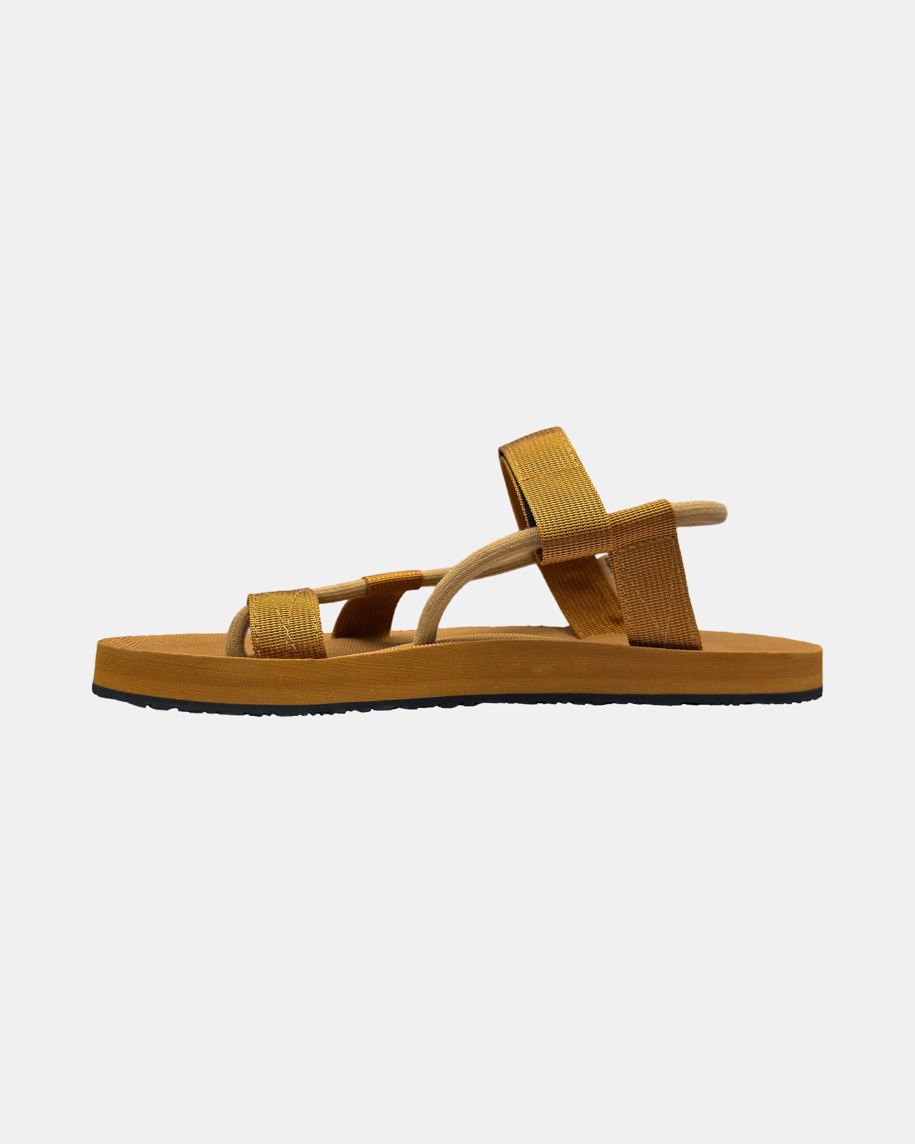 Men's earth brown rubber Roman-style sandal seen from the left side, highlighting the contoured and grooved topsole with embedded arch support.