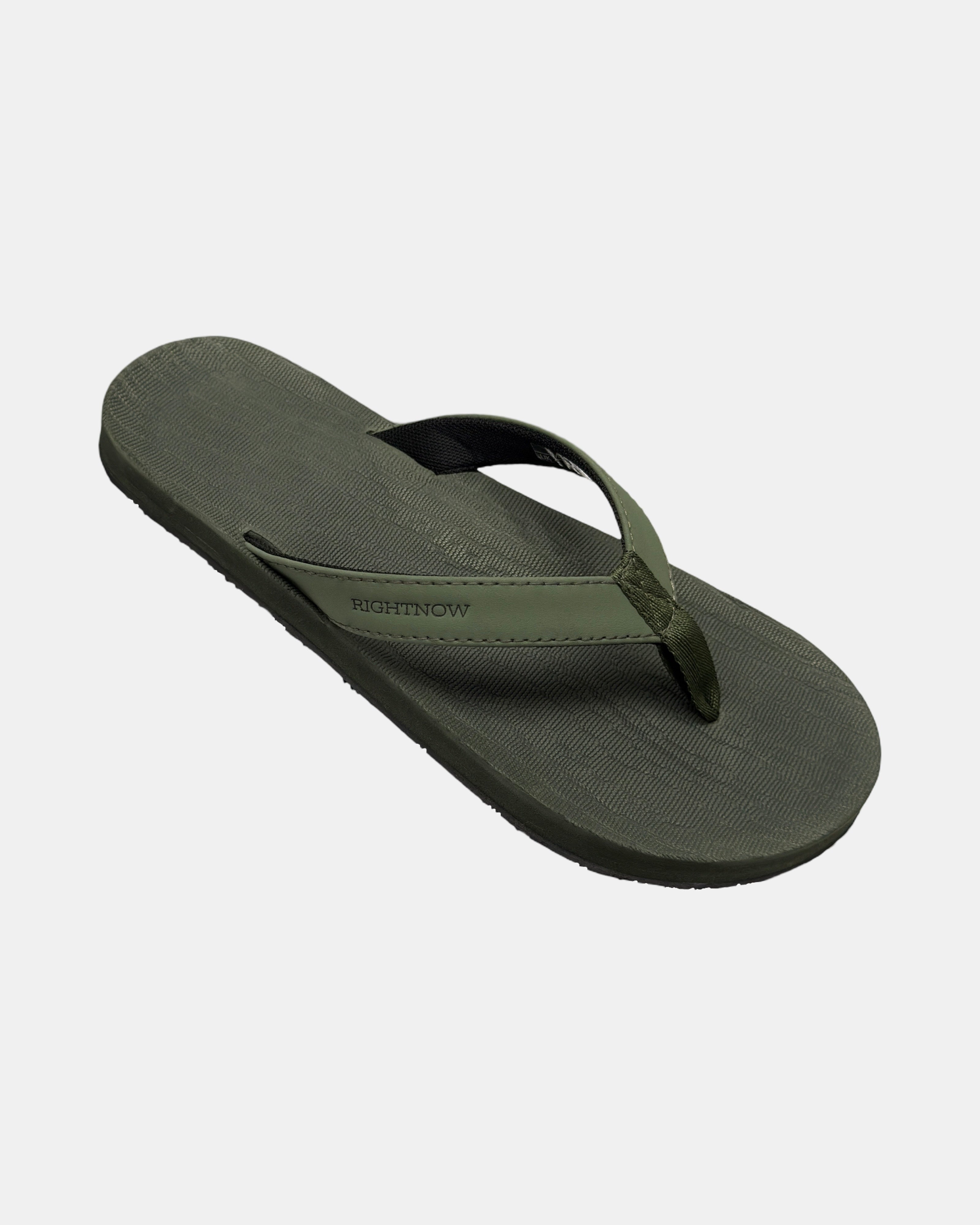 A 45-degree angled view of a men's natural green rubber Thong-style sandal highlighting its textured and supportive footbed.