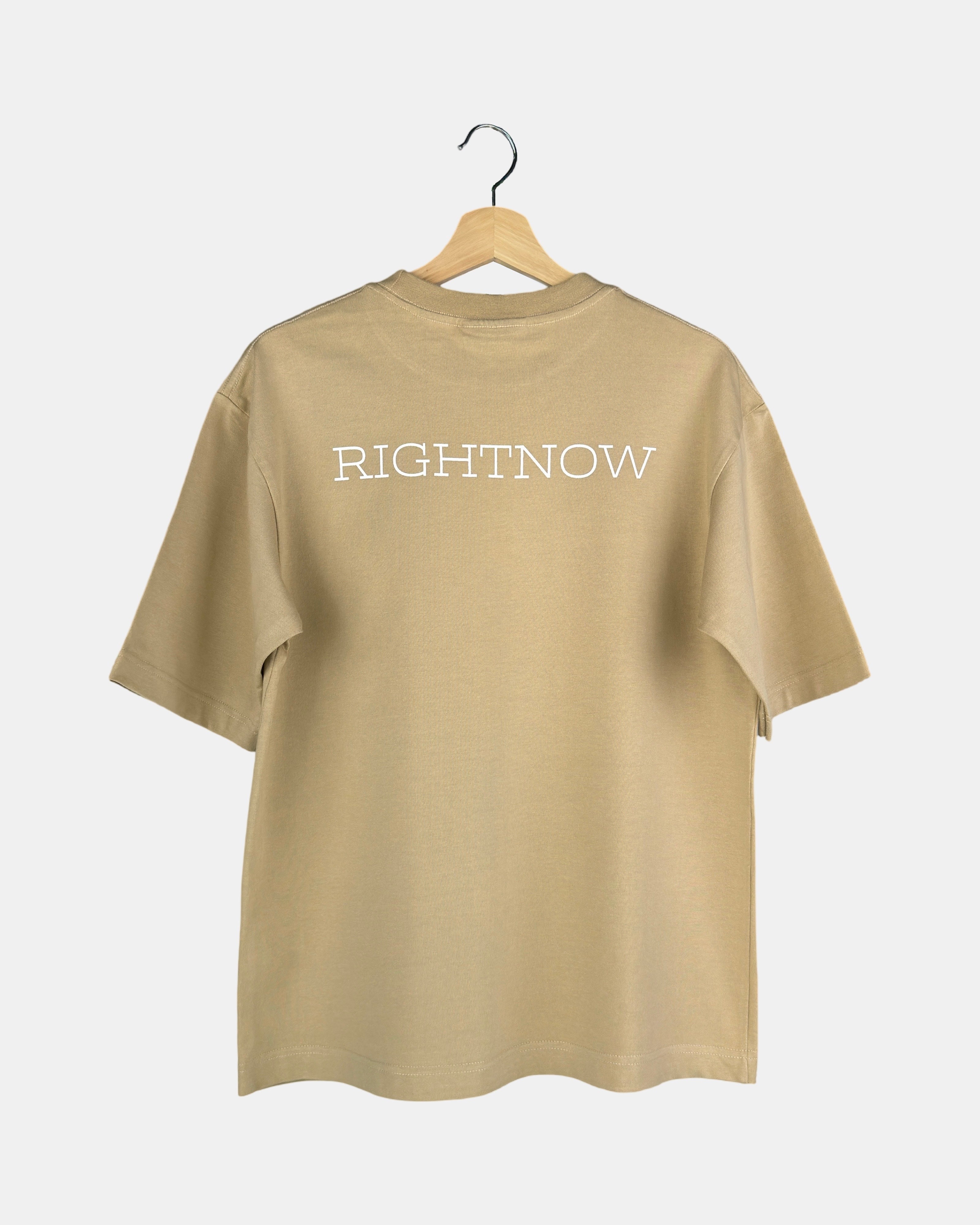 Back view of a unisex, sand beige, cotton, oversized RIGHTNOW logo t-shirt with the brand name printed in large letters across the upper back.