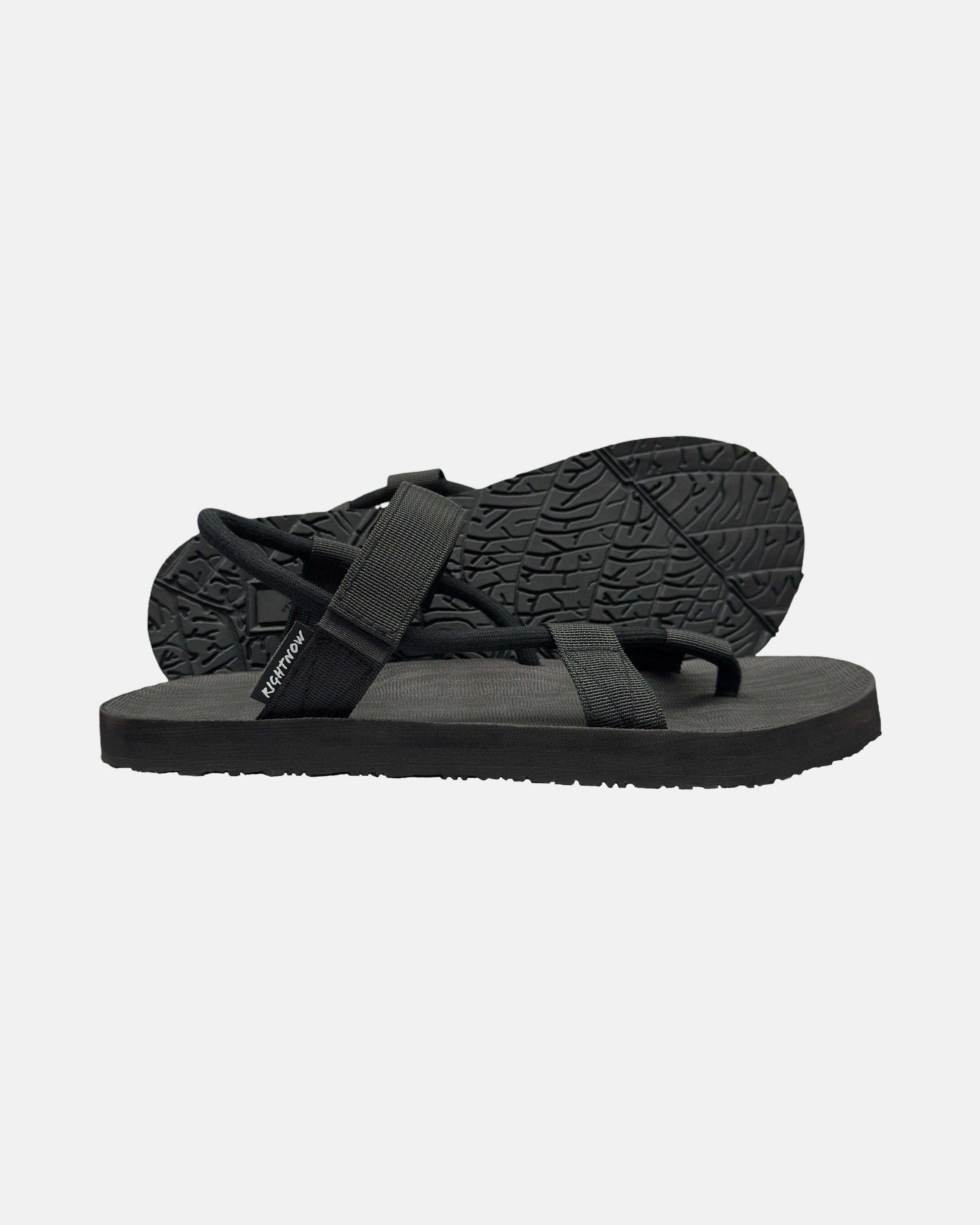 Women's elegant-tone minimalist sandal with flexible strap and an open-toe design, with the black rubber textured anti-slip sole behind it.