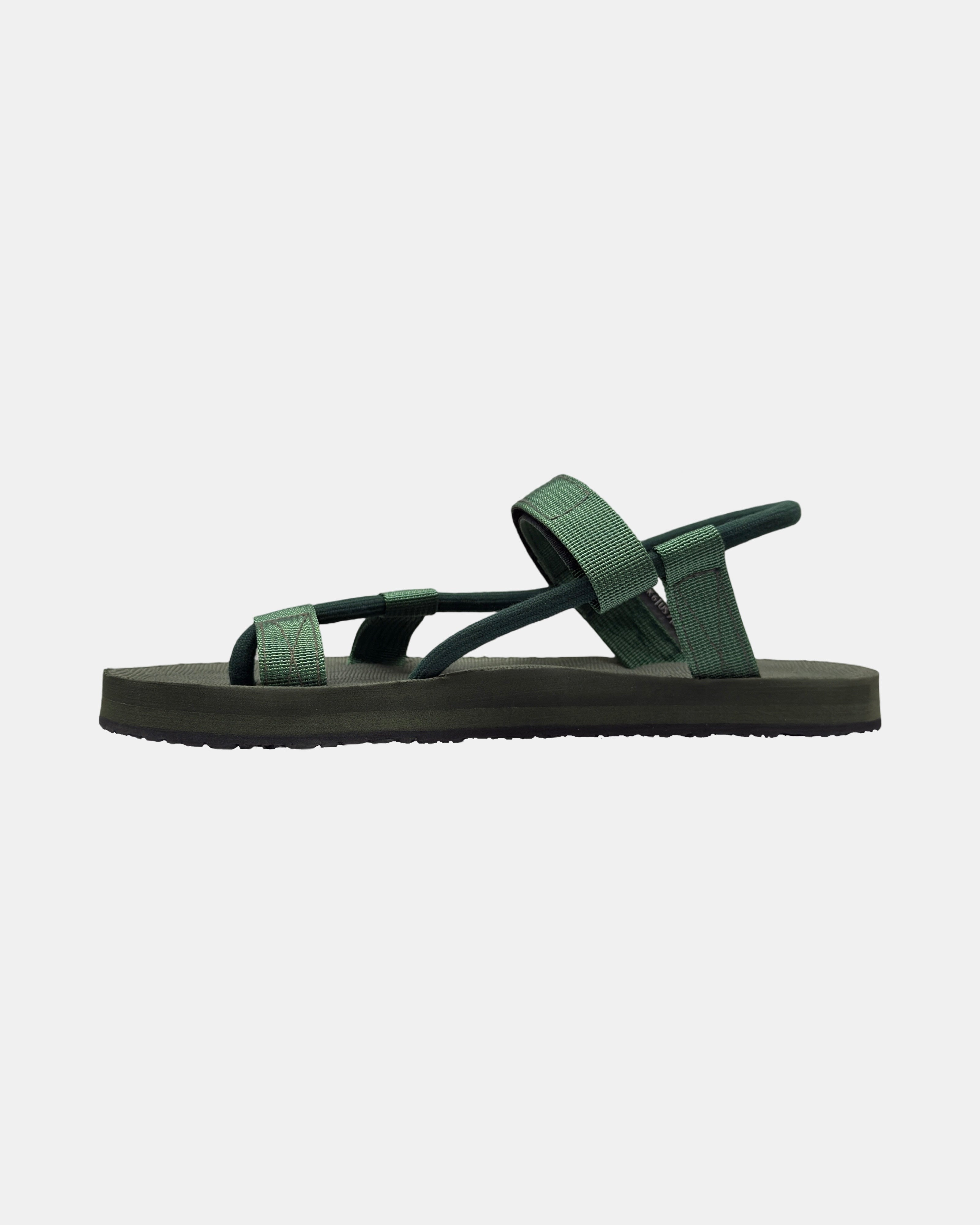 Women's natural green rubber Roman-style sandal seen from the left side, highlighting the contoured and grooved topsole with embedded arch support.