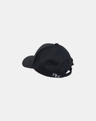 Angled 45-degree back-left view of a matt black Ignite cap, featuring the full 'RN' brand logo embroidery, quietly inspiring everyone to be present.