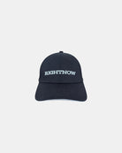 Front view of a matt black minimalist baseball cap featuring the ‘RIGHTNOW’ logo in white embroidery for simple, everyday style.