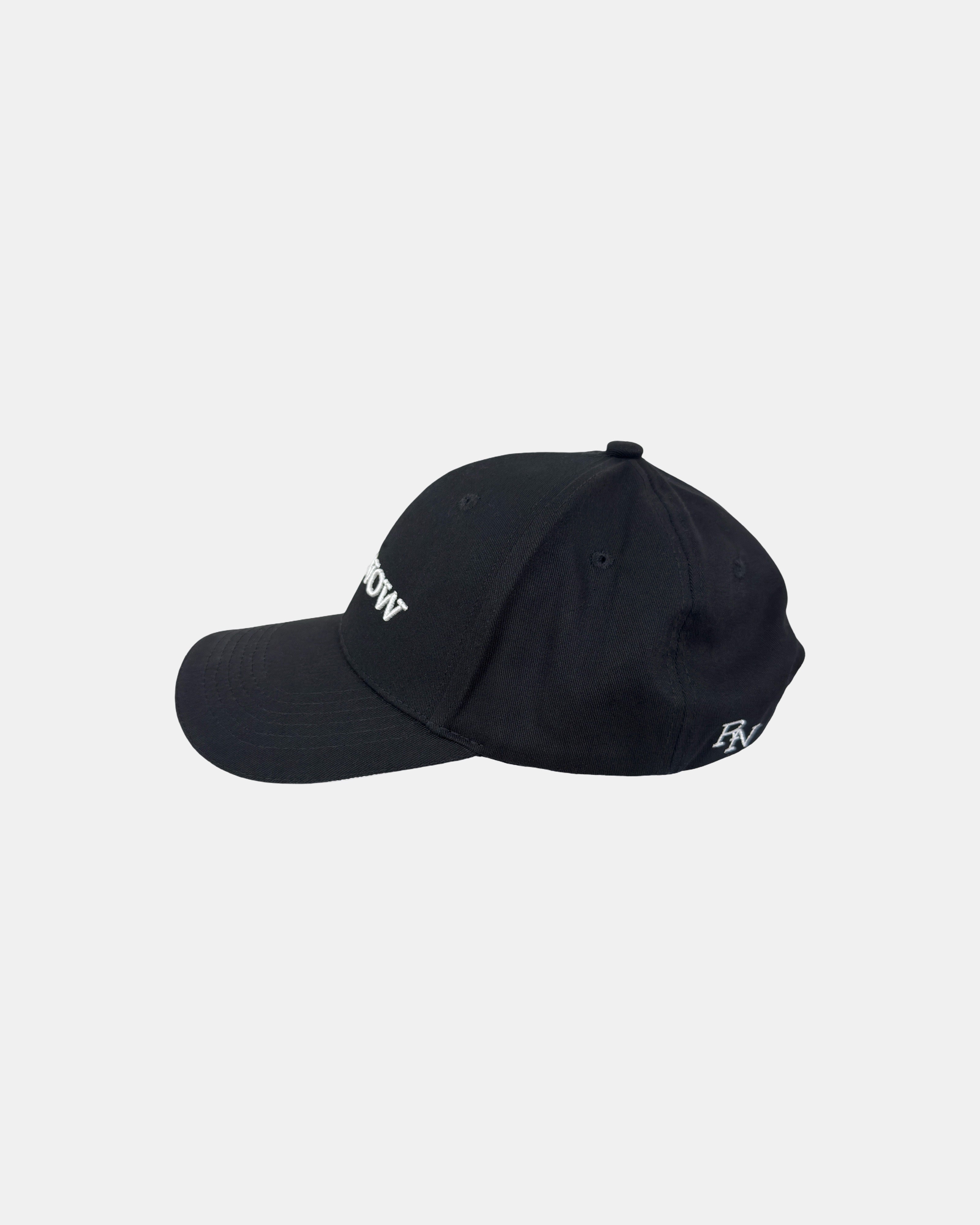 Left side profile of the Ignite RIGHTNOW logo baseball cap in matt black, showing its classic six-panel construction and curved brim for a timeless look.
