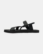 Men's matt black rubber Roman-style sandal seen from the left side, highlighting the contoured and grooved topsole with embedded arch support.