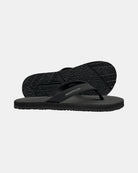Men's elegant-tone minimalist thong sandal with V-shaped strap and an open-toe design, with the black rubber textured anti-slip sole behind it.