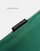 Brand logo label sewn on the outside of a natural green Moment cotton oversized plain t-shirt.