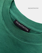 Brand logo label sewn on the back of the collar of a natural green Moment cotton oversized t-shirt.