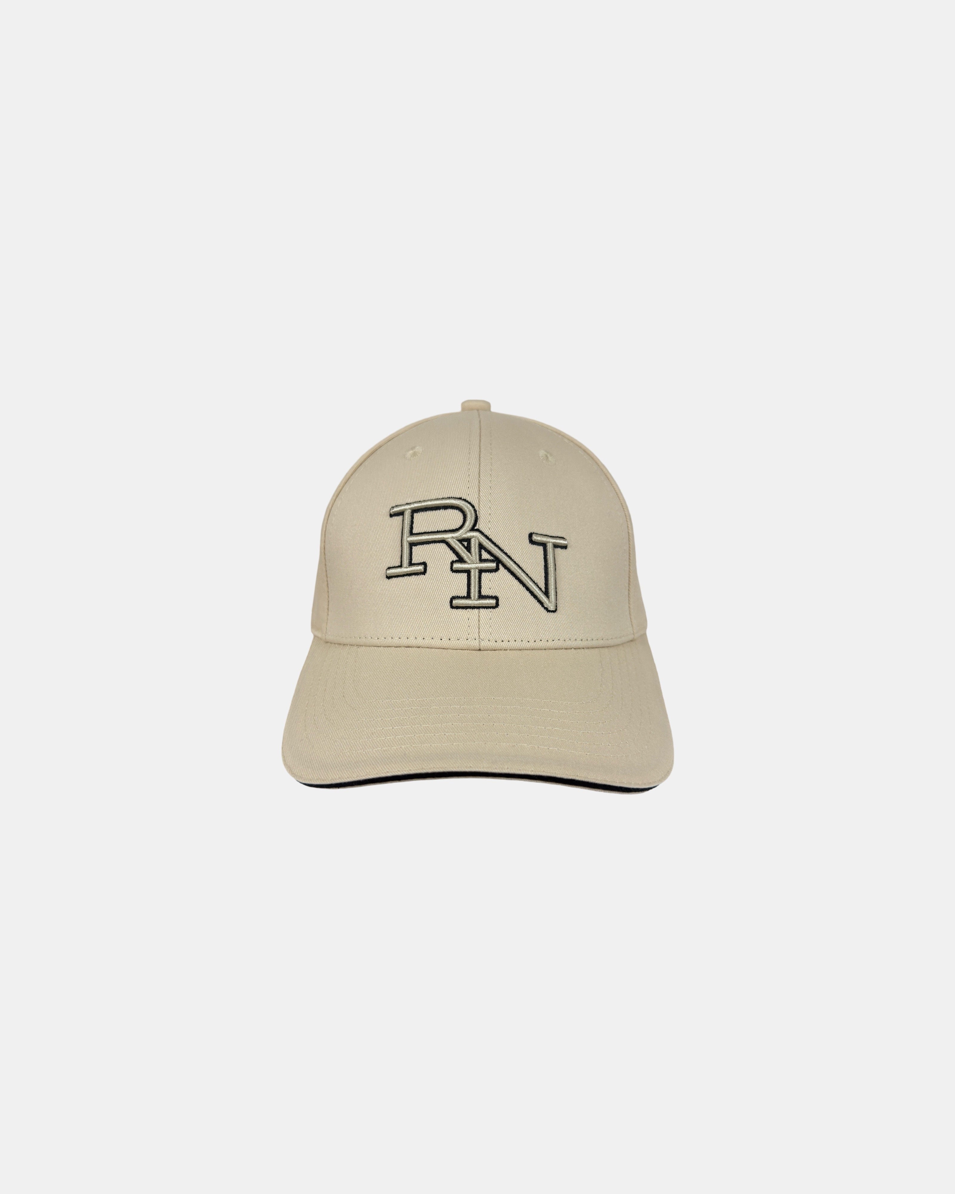 Front view of a sand beige minimalist baseball cap featuring the ‘RN’ logo in black outline embroidery for simple, everyday style.