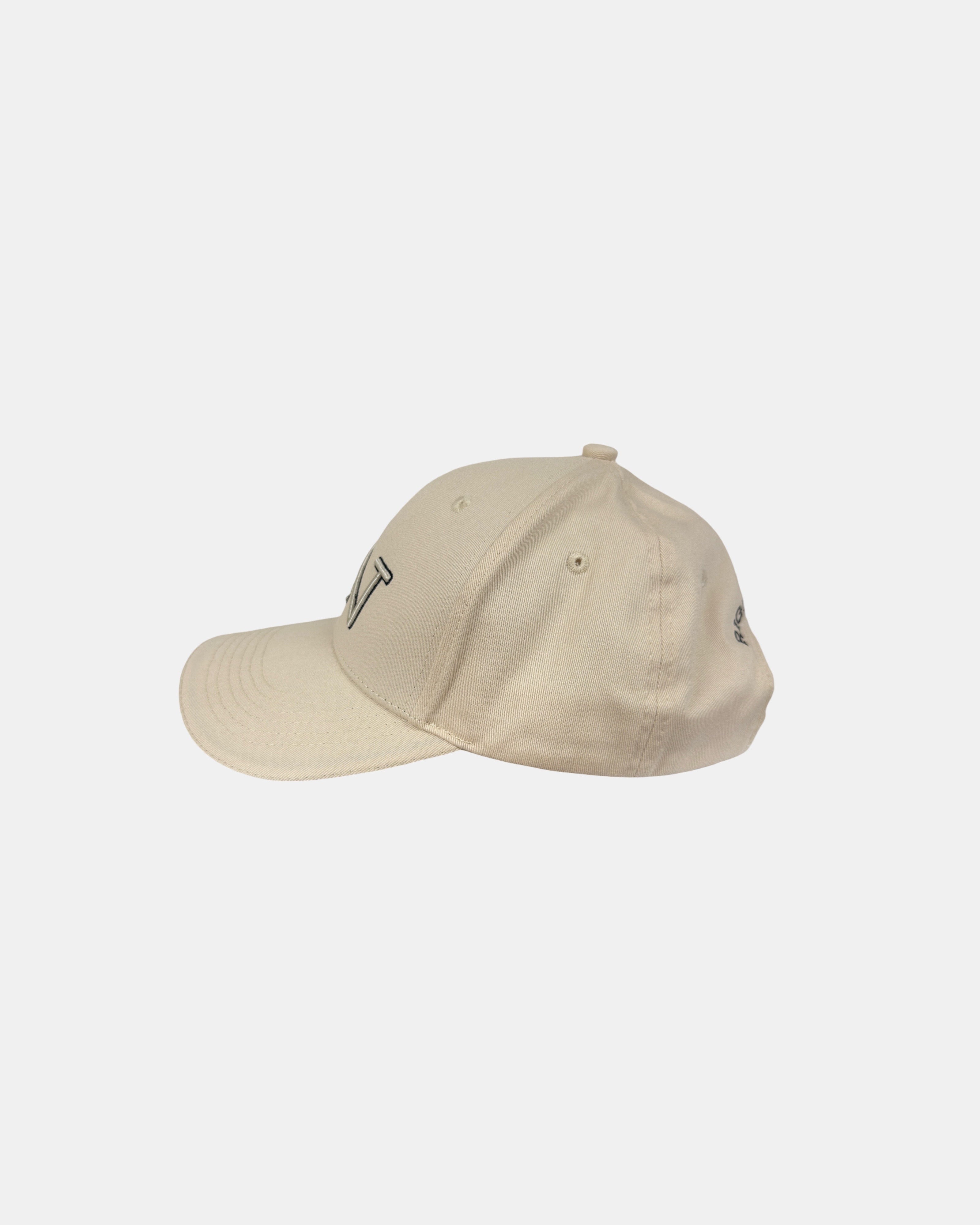 Left side profile of the Ignite RN logo baseball cap in sand beige, showing its classic six-panel construction and curved brim for a timeless look.