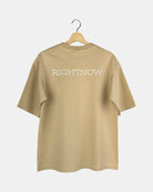 Back view of a unisex, sand beige, cotton, oversized RIGHTNOW logo t-shirt with the brand name printed in large letters across the upper back.