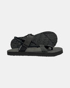 Women's elegant-tone minimalist sandal with flexible strap and an open-toe design, with the black rubber textured anti-slip sole behind it.