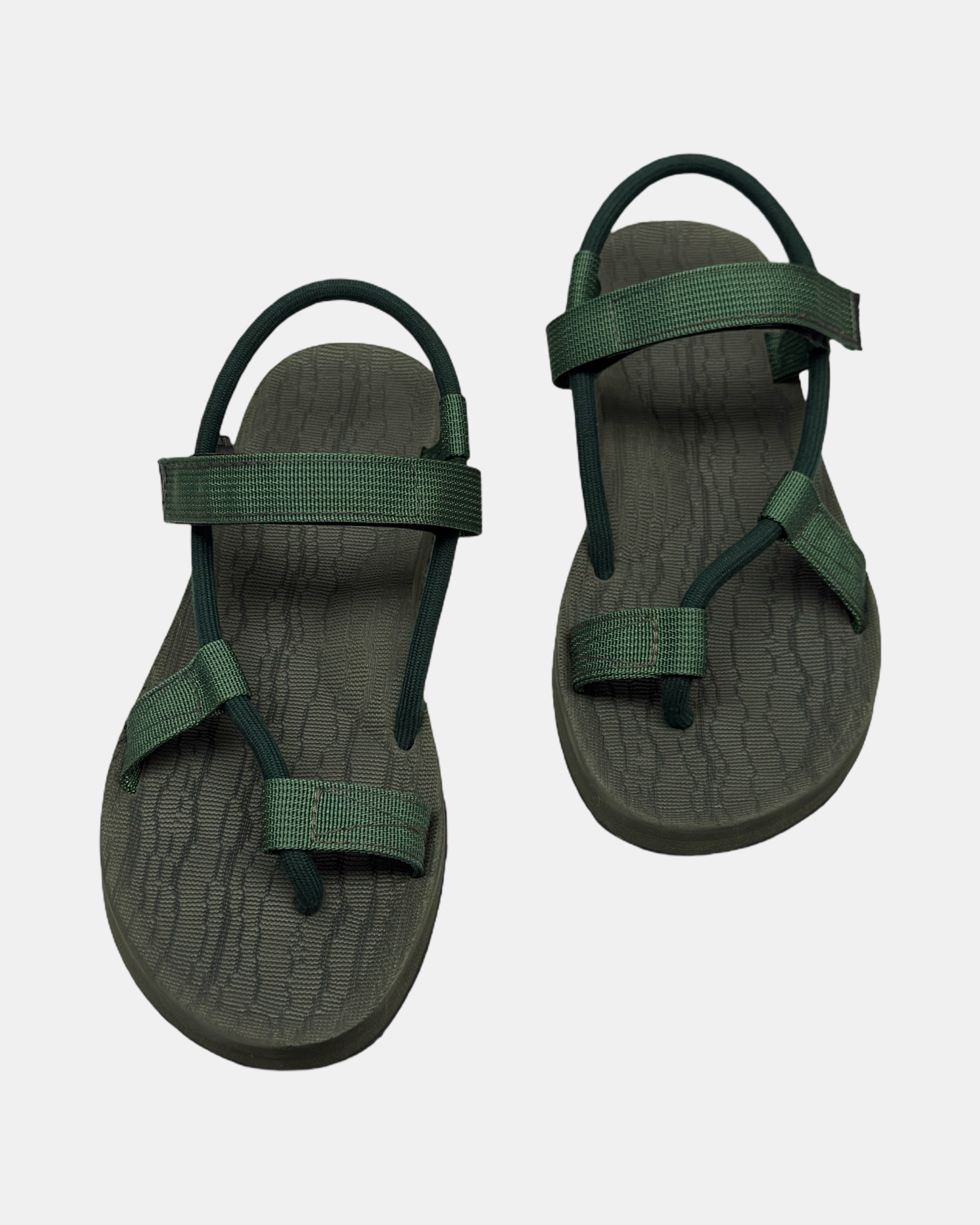 Front view of a pair of natural green rubber women’s roman sandal with open-toe design and adjustable ankle strap.