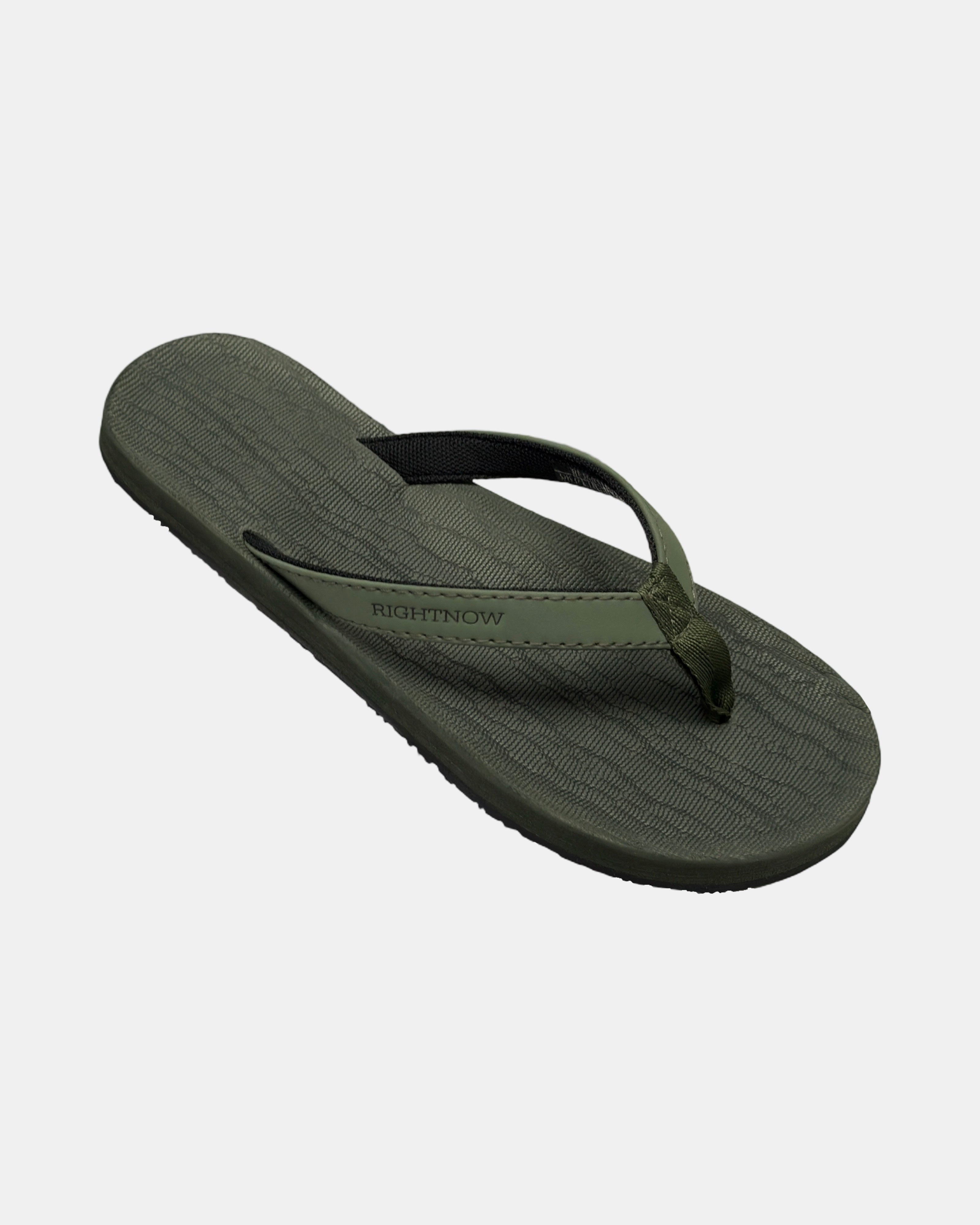 A 45-degree angled view of a women's natural green rubber Thong-style sandal highlighting its textured and supportive footbed.